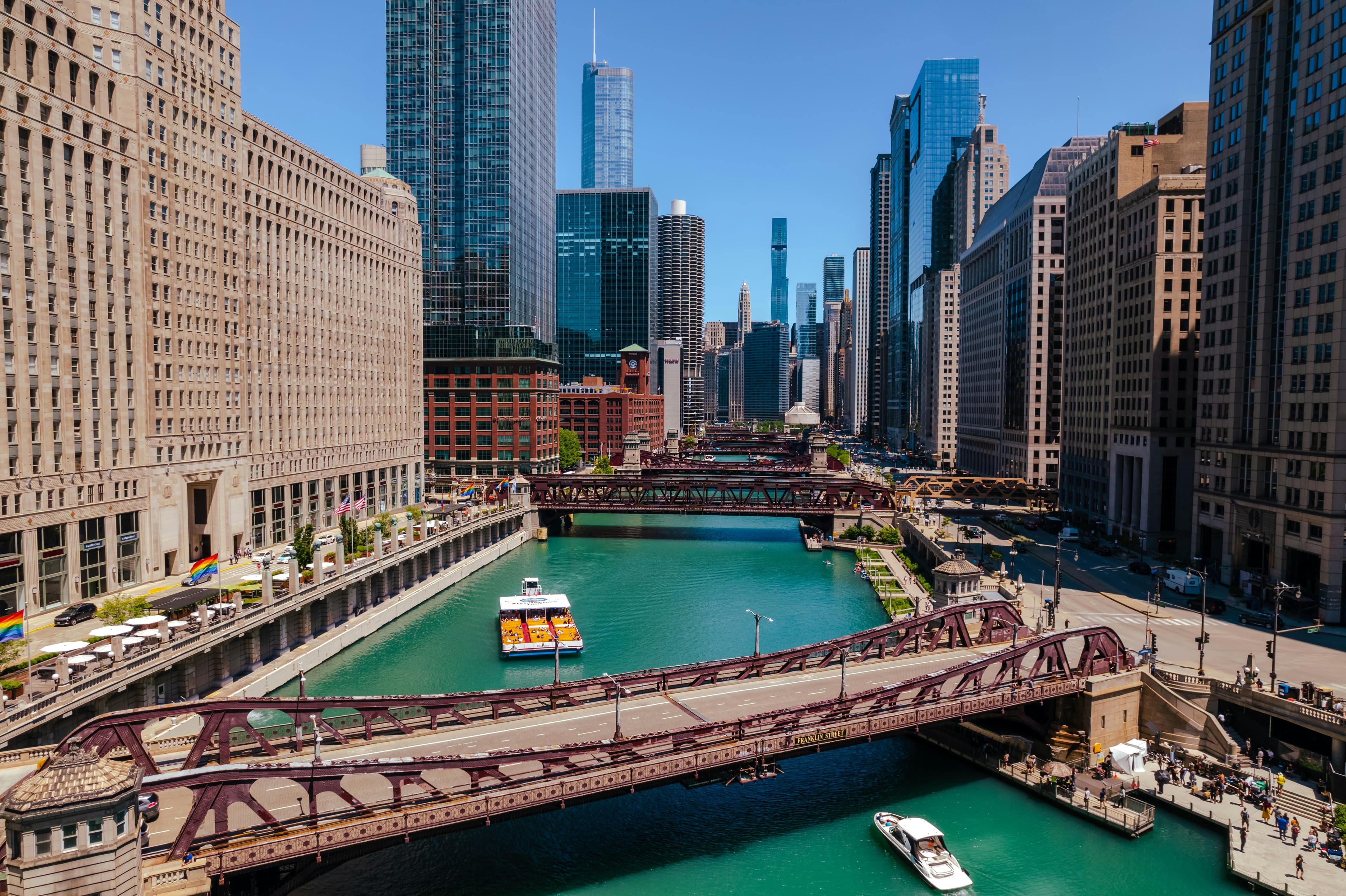 Boats on the Chicago River between downtown towers